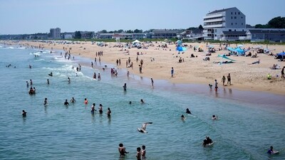 The cool waters of the Atlantic Ocean attract a crowd to Old Orchard Beach, Maine, Tuesday, June 18, 2024. The heat wave that has been hitting much of the United States is now moving into the Northeast. (AP) The cool waters of the Atlantic Ocean attract a crowd to Old Orchard Beach, Maine, Tuesday, June 18, 2024. The heat wave that has been hitting much of the United States is now moving into the Northeast. (AP)