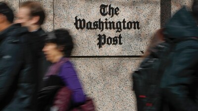 People walk by the One Franklin Square Building, home of The Washington Post newspaper, in downtown Washington. (AP)