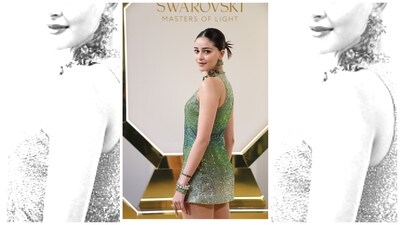 The tiny green dress was embedded with thousands of crystals in various shades of green. The tiny green dress was embedded with thousands of crystals in various shades of green. 