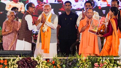 Varanasi: Prime Minister Narendra Modi being greeted by union minister Shivraj Singh Chouhan during the Kisan Samman Sammelan. (PTI) Varanasi: Prime Minister Narendra Modi being greeted by union minister Shivraj Singh Chouhan during the Kisan Samman Sammelan. (PTI)