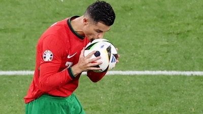 Portugal's Cristiano Ronaldo kisses the ball during the match (REUTERS)