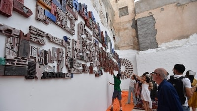 Tunisians attend the inauguration of the '1001 Bricks Fresco', a participatory artwork by more than 500 inhabitants of Tunis led by Swiss artist Anne Francey, illustrating the diversity of the city, with the bas relief installed on the edge of the medina, the old town listed by UNESCO, in the capital's El-Hafsia district on June 7, 2024. The installation showcases the talents of "invisible" creators, including art students, people with disabilities and school dropouts. (AFP) Tunisians attend the inauguration of the '1001 Bricks Fresco', a participatory artwork by more than 500 inhabitants of Tunis led by Swiss artist Anne Francey, illustrating the diversity of the city, with the bas relief installed on the edge of the medina, the old town listed by UNESCO, in the capital's El-Hafsia district on June 7, 2024. The installation showcases the talents of "invisible" creators, including art students, people with disabilities and school dropouts. (AFP)