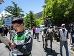 A tourist rides a horse near the Fuji Subaru Line 5th station, which leads to the popular Yoshida trail for hikers climbing Mount Fuji, ahead of its reopening for the season at Narusawa, Yamanashi Prefecture. 