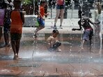 Children play in a city water feature during a heatwave affecting the U.S. Northeast in Boston, Massachusetts, U.S. June 19, 2024.