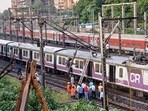 Mumbai weather: Mumbai's local train services on the Central Railway were affected after an overhead equipment pole between Thane and Mulund stations got bent due to strong winds. (HT photo/ Praful Gangurde)