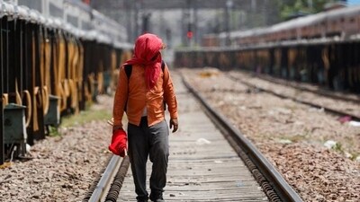 A man covers his face using a cloth to shield himself from the sun as he inspects railway tracks during a hot summer day in New Delhi. (REUTERS) A man covers his face using a cloth to shield himself from the sun as he inspects railway tracks during a hot summer day in New Delhi. (REUTERS)