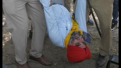 AAP leader SS Ahluwalia being taken to the Industrial Area Phase 1 police station on Wednesday. (Ravi Kumar/ HT)