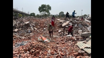 Ragpickers on site sifting for iron from the debris in Akbar Nagar, on Wednesday (HT Photo) Ragpickers on site sifting for iron from the debris in Akbar Nagar, on Wednesday (HT Photo)