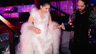 Radhika Merchant's latest photos showcase her sartorial elegance and fashion finesse. Her blush pink tulle gown features layered tulle on the exaggerated shoulder pads, a plunging v-neckline, a corseted bodice that accentuates the waist, a pleated skirt that shapes the figure, a deep back, an asymmetric hem and a long train that cascades behind. Complemented with glamorous make-up and luxurious accessories, she exudes pure sophistication. (Instagram) Radhika Merchant's latest photos showcase her sartorial elegance and fashion finesse. Her blush pink tulle gown features layered tulle on the exaggerated shoulder pads, a plunging v-neckline, a corseted bodice that accentuates the waist, a pleated skirt that shapes the figure, a deep back, an asymmetric hem and a long train that cascades behind. Complemented with glamorous make-up and luxurious accessories, she exudes pure sophistication. (Instagram)