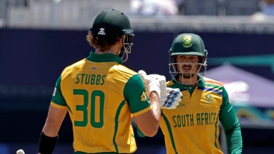 South Africa's Quinton de Kock, right, and batting parter Tristan Stubbs celebrate scoring runs (AP)