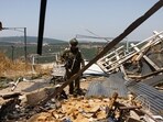 An Israeli soldier at the site of an Hezbollah anti-tank missile direct hit on a house near the Lebanon border in Moshav Shtula. An Israeli soldier at the site of an Hezbollah anti-tank missile direct hit on a house near the Lebanon border in Moshav Shtula.