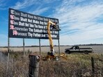FILE - Workers repaint a Ten Commandments billboard off of Interstate 71 on Election Day near Chenoweth, Ohio, Tuesday, Nov. 7, 2023. Louisiana has become the first state to require that the Ten Commandments be displayed in every public school classroom under a bill signed into law by Republican Gov. Jeff Landry on Wednesday. (AP Photo/Carolyn Kaster, File) FILE - Workers repaint a Ten Commandments billboard off of Interstate 71 on Election Day near Chenoweth, Ohio, Tuesday, Nov. 7, 2023. Louisiana has become the first state to require that the Ten Commandments be displayed in every public school classroom under a bill signed into law by Republican Gov. Jeff Landry on Wednesday. (AP Photo/Carolyn Kaster, File)