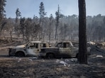 Vehicles sit outside a destroyed residence in the aftermath of the South Fork fire in Alto, New Mexico, U.S., June 19, 2024.  REUTERS/Adrees Latif