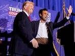 Vivek Ramaswamy, who ended his Republican presidential campaign, and Republican presidential candidate and former U.S. President Donald Trump gesture on stage at a campaign rally ahead of the New Hampshire primary election, in Atkinson, New Hampshire, U.S. January 16, 2024 (REUTERS/Elizabeth Frantz)