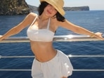 Kylie Jenner in a white two-piece set with a bralette and a puff skirt Kylie Jenner in a white two-piece set with a bralette and a puff skirt