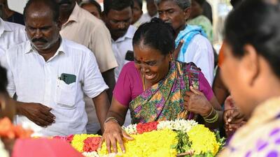 A family member weeps next to the dead body of a victim who died after consuming toxic alcohol in Kallakurichi district of Tamil Nadu. (AFP) A family member weeps next to the dead body of a victim who died after consuming toxic alcohol in Kallakurichi district of Tamil Nadu. (AFP)