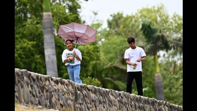 A girl enjoys the cloudy weather at Sukhna Lake in Chandigarh on Thursday. (Ravi Kumar/HT)