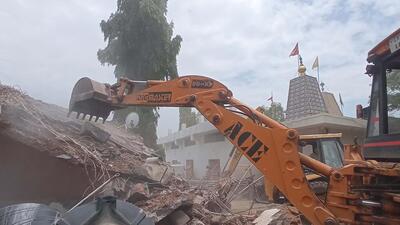 Chandigarh MC teams taking down illegal constructions at the temple complex in Manimajra. (Sant Arora/HT)