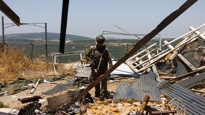 An Israeli soldier at the site of an Hezbollah anti-tank missile direct hit on a house near the Lebanon border in Moshav Shtula. (Bloomberg) An Israeli soldier at the site of an Hezbollah anti-tank missile direct hit on a house near the Lebanon border in Moshav Shtula. (Bloomberg)