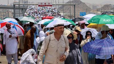 Muslim pilgrims walk with umbrellas on the third day of the Satan stoning ritual, amid extremely hot weather, during the annual haj pilgrimage in Mina. (REUTERS) Muslim pilgrims walk with umbrellas on the third day of the Satan stoning ritual, amid extremely hot weather, during the annual haj pilgrimage in Mina. (REUTERS)