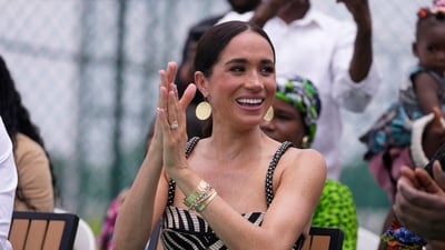 Meghan Markle watches her husband Prince Harry play in an exhibition sitting volleyball match, in Abuja, Nigeria, Saturday, May 11, 2024.s. (AP Photo/Sunday Alamba) (AP) Meghan Markle watches her husband Prince Harry play in an exhibition sitting volleyball match, in Abuja, Nigeria, Saturday, May 11, 2024.s. (AP Photo/Sunday Alamba) (AP)