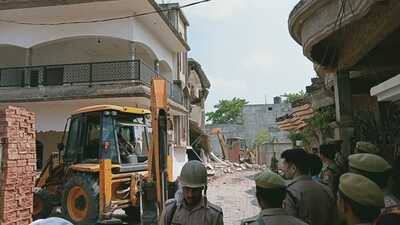 PDA vehicle demolishing the illegal construction on waqf property in Sallahpur area of Puramufti on Thursday. (HT PHOTO)