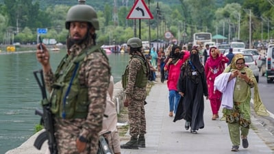 Security personnel stand guard near the SKICC in Srinagar (PTI) Security personnel stand guard near the SKICC in Srinagar (PTI)