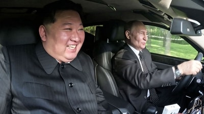 North Korea's leader Kim Jong Un (L) sitting in the passenger seat of a car driven by Russia's President Vladimir Putin (R) in the garden of the Kumsusan State Guesthouse in Pyongyang. (AFP)