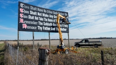 FILE - Workers repaint a Ten Commandments billboard off of Interstate 71 on Election Day near Chenoweth, Ohio, Tuesday, Nov. 7, 2023. Louisiana has become the first state to require that the Ten Commandments be displayed in every public school classroom under a bill signed into law by Republican Gov. Jeff Landry on Wednesday. (AP Photo/Carolyn Kaster, File) (AP) FILE - Workers repaint a Ten Commandments billboard off of Interstate 71 on Election Day near Chenoweth, Ohio, Tuesday, Nov. 7, 2023. Louisiana has become the first state to require that the Ten Commandments be displayed in every public school classroom under a bill signed into law by Republican Gov. Jeff Landry on Wednesday. (AP Photo/Carolyn Kaster, File) (AP)