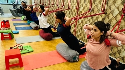 Yoga enthusiasts performing Iyengar yoga at a city gym Yoga enthusiasts performing Iyengar yoga at a city gym