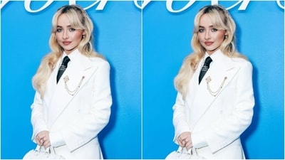 Sabrina Carpenter looked stunning in a white suit as she attended Louis Vuitton's Menswear show. In a white shirt, teamed with a white suit and a black tie, Sabrina accessorised her look with a mini white bag. (Shutterstock) Sabrina Carpenter looked stunning in a white suit as she attended Louis Vuitton's Menswear show. In a white shirt, teamed with a white suit and a black tie, Sabrina accessorised her look with a mini white bag. (Shutterstock)
