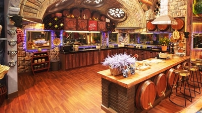 The distinct features in the third season continue with a kitchen that resembles a quaint vineyard, complete with stone walls and whimsical wine barrels, creating a cozy yet playful vibe. A large bridge connects the living room and storeroom, suspended over a water-printed carpet, adding a serene touch to the Bigg Boss house. 