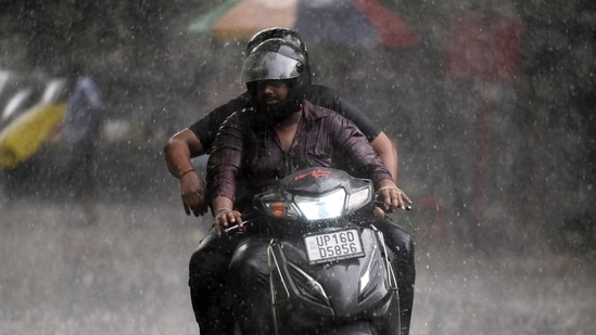 Commuters travel during light rain in Noida, (Sunil Ghosh /HT file) Commuters travel during light rain in Noida, (Sunil Ghosh /HT file)