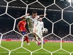 Italy's Riccardo Calafiori scores an own goal.