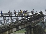 Villagers use a temporary bamboo bridge to cross a river after the bridge over it washed away in flood water at Subankhata village in Assam’s Baksa district on Sunday. (PTI) Villagers use a temporary bamboo bridge to cross a river after the bridge over it washed away in flood water at Subankhata village in Assam’s Baksa district on Sunday. (PTI)