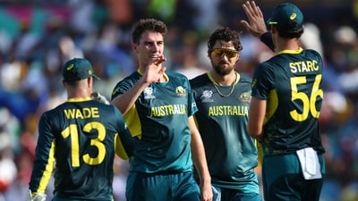 Australia's Pat Cummins celebrates with teammates after taking the wicket of England's Liam Livingstone. (Reuters)