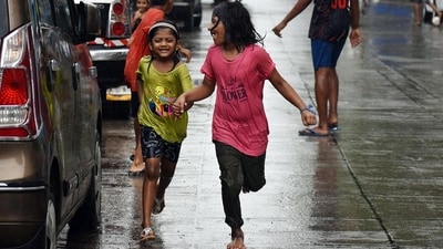 Children play in the rain in Mumbai. (ANI Photo)