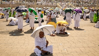 Muslim pilgrims use umbrellas to shade themselves from the sun as they arrive at the base of Mount Arafat, also known as Jabal al-Rahma or Mount of Mercy, during the annual hajj pilgrimage on June 15, 2024. (AFP) Muslim pilgrims use umbrellas to shade themselves from the sun as they arrive at the base of Mount Arafat, also known as Jabal al-Rahma or Mount of Mercy, during the annual hajj pilgrimage on June 15, 2024. (AFP)