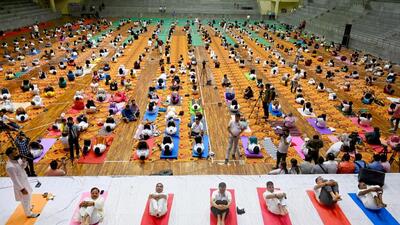 The program held at Noida’s Indoor Stadium began with a lamp-lighting ceremony, followed by ministers and senior party leaders performing various ‘asanas.’ (Sunil Ghosh/HT Photo) The program held at Noida’s Indoor Stadium began with a lamp-lighting ceremony, followed by ministers and senior party leaders performing various ‘asanas.’ (Sunil Ghosh/HT Photo)