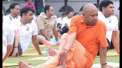 Uttar Pradesh chief minister Yogi Adityanath doing yoga at Raj Bhavan in Lucknow on June 21. (HT photo)