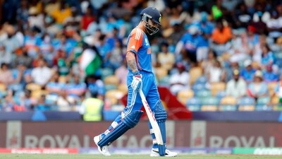 India's Virat Kohli walks back to the pavilion after being dismissed by Afghanistan's captain Rashid Khan. (AP) India's Virat Kohli walks back to the pavilion after being dismissed by Afghanistan's captain Rashid Khan. (AP)