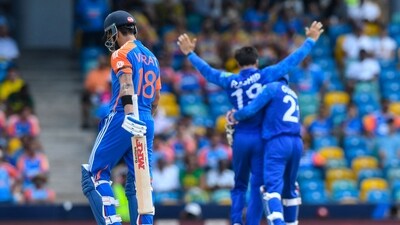 India's Virat Kohli (L) walks off the field after being dismissed by Afghanistan's captain Rashid Khan (R). (AFP) India's Virat Kohli (L) walks off the field after being dismissed by Afghanistan's captain Rashid Khan (R). (AFP)