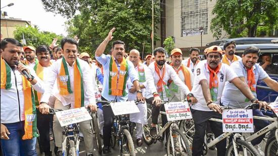 BJP Karnataka President BY Vijayendra along with other party workers and leaders during a protest against the state government over alleged fuel price hike in Bengaluru on Thursday. (PTI)