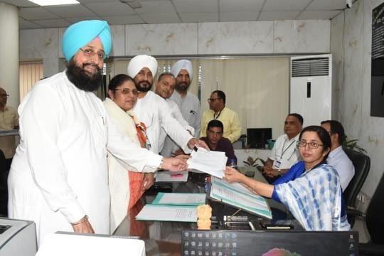 Congress leaders Partap Singh Bajwa and former CM Charanjit Channi accompanied Congress nominee Surinder Kaur as she submitted the her nomination papers with returning officer Alka Kalia on Friday. (HT Photo) Congress leaders Partap Singh Bajwa and former CM Charanjit Channi accompanied Congress nominee Surinder Kaur as she submitted the her nomination papers with returning officer Alka Kalia on Friday. (HT Photo)