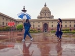 People enjoys rain at Nouth Block, Raisina Hills, in New Delhi, on Friday, June 21, 2024. 
