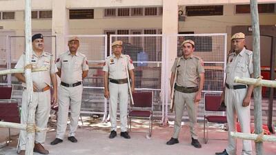 Gurugram, India-May 26, 2024: Haryana Police and Central Industrial Security Force (CISF) stand guard outside a sealed 'strong room' where electronic voting machines (EVM) are kept following Lok Sabha election of Haryana state at Government Girl College in sector-14, in Gurugram, India, on Sunday, 26 May 2024. (Photo by Parveen Kumar/Hindustan Times)