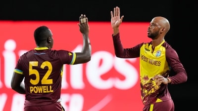 West Indies' Roston Chase, right, is congratulated by teammate Rovman Powell after dismissing United States' Aaron Jones during the men's T20 World Cup cricket match between the USA and the West Indies at Kensington Oval (PTI) West Indies' Roston Chase, right, is congratulated by teammate Rovman Powell after dismissing United States' Aaron Jones during the men's T20 World Cup cricket match between the USA and the West Indies at Kensington Oval (PTI)
