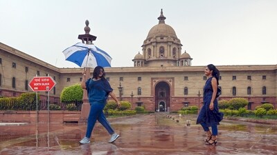 People enjoys rain at Nouth Block, Raisina Hills, in New Delhi, on Friday, June 21, 2024. ((Photo by Sanjeev Verma/ Hindustan Times)) People enjoys rain at Nouth Block, Raisina Hills, in New Delhi, on Friday, June 21, 2024. ((Photo by Sanjeev Verma/ Hindustan Times))