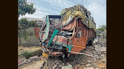 The truck damaged two electricity poles before ramming into the wall of a compound on Hambran Road in Ludhiana. (HT Photo)