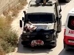 Israeli army straps Palestinian on military jeep during raid in Jenin, in this screengrab from a video, in the Israeli-occupied West Bank, June 22, 2024. 